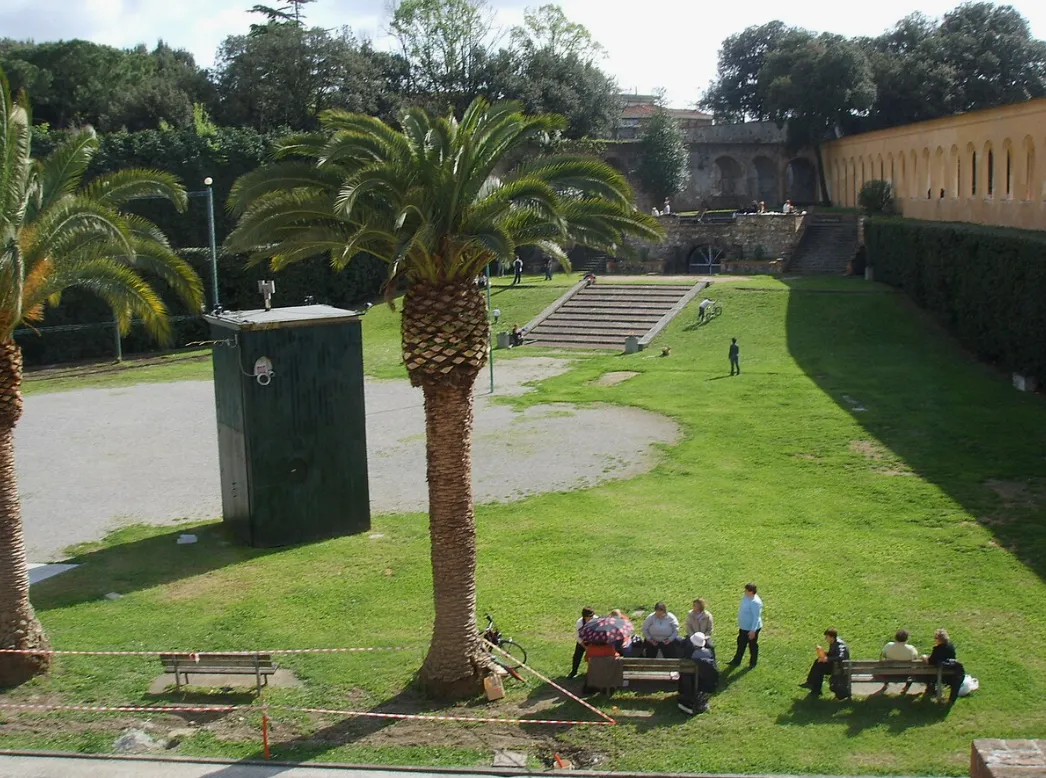 Locals relaxing at Giardino Scotto park with palm trees and open lawns