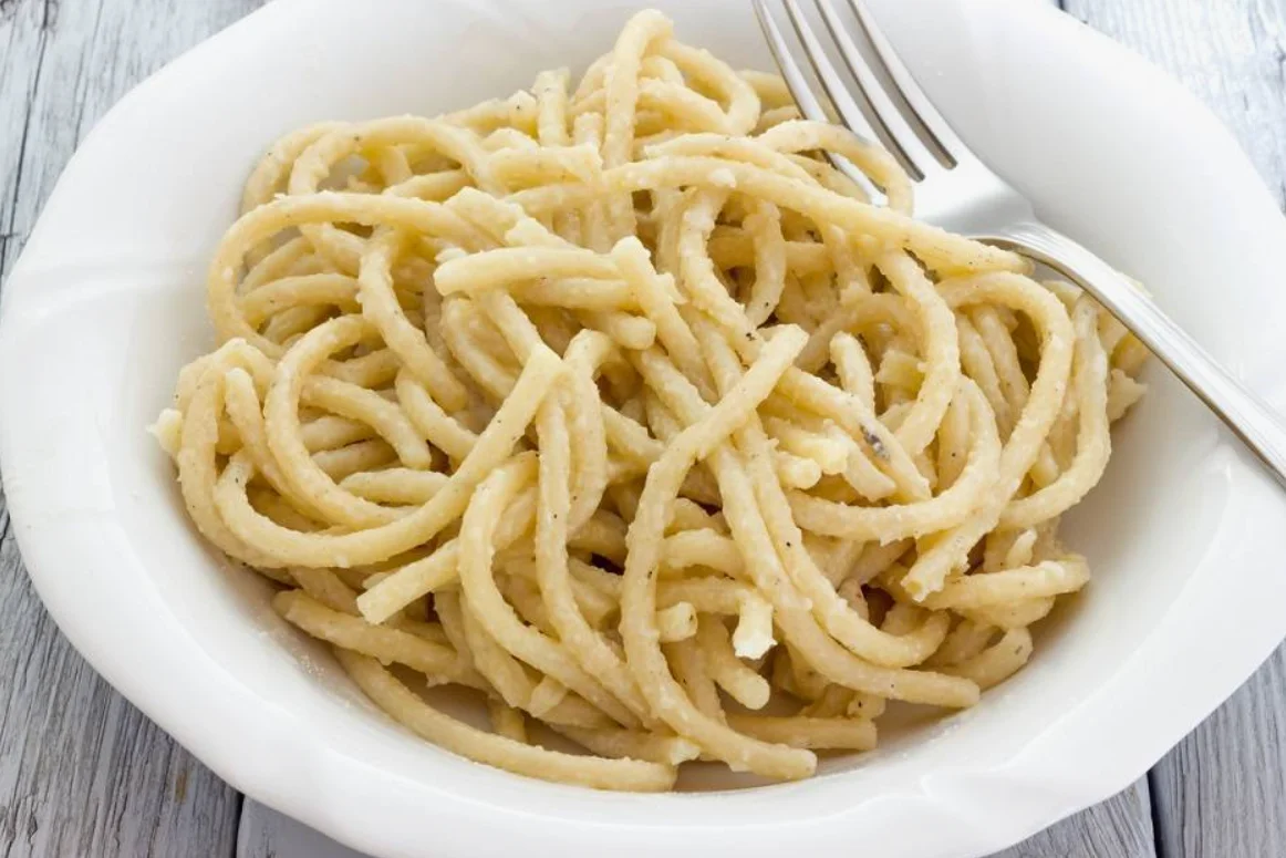 Pici, traditional hand-rolled Tuscan pasta served in Pisa, Italy